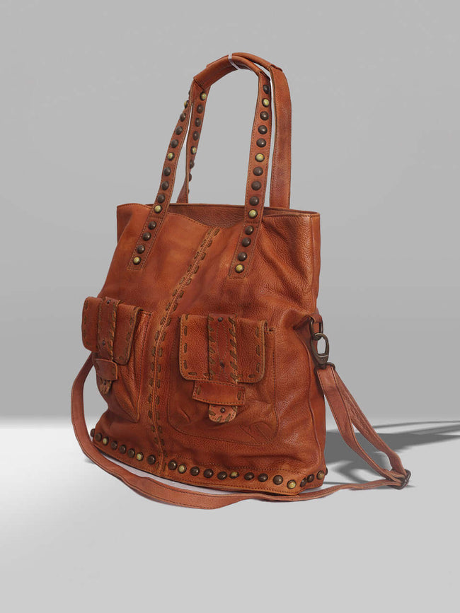 Tan handbag with studs on it